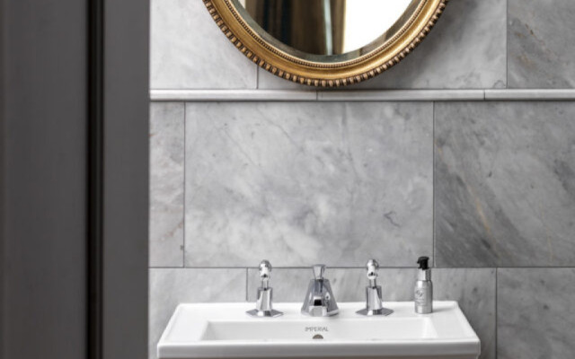 Elegant bathroom design featuring a stylish sink and a decorative mirror.