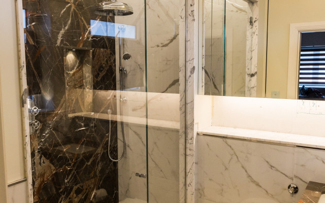 Elegant Walk-in Shower with Integrated Toilet Design