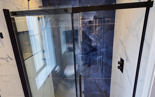 Elegant blue-black shower cubicle showcasing stylish design and modern functionality.
