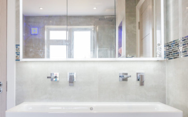 Elegant floating basin vanity with LED mirror.