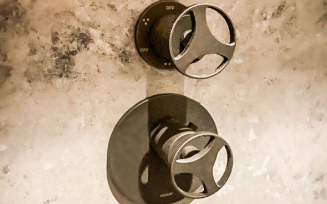 Elegant designer wall shower valves showcased in a luxurious setting.
