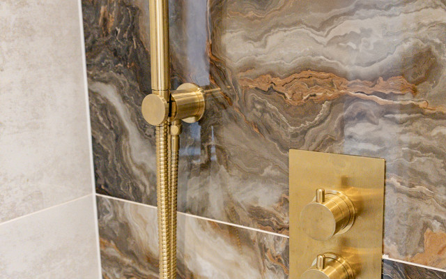 Elevate your space with a stunning wetroom hand shower featuring a luxurious brass finish.