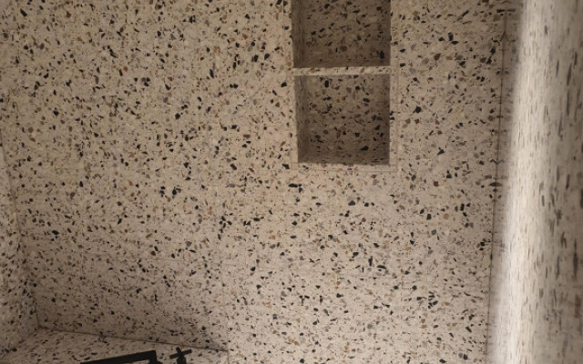 Explore luxury and functionality with our stylish bathroom design featuring elegant terrazzo finishes.