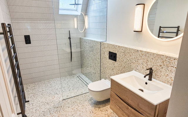 Highgate Shower Room - A contemporary and stylish bathroom featuring textured tiles and a modern aesthetic.