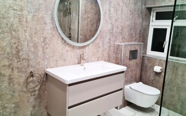 Elevate your bathroom with this stunning salmon pink wall-hung toilet and stylish vanity unit.