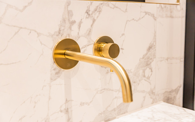 Elegant gold wall-hung tap, perfect for modern bathrooms.