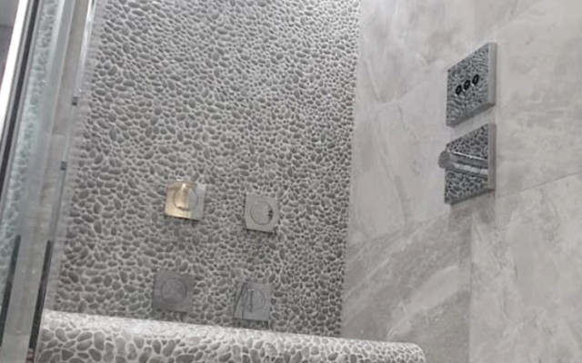 Experience a walk-in shower with luxurious design and functionality.